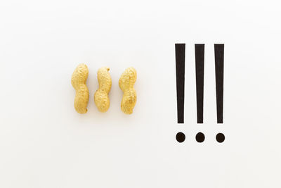 Concept of the saying thats peanuts. raw peanuts and black ink hand writing on white background
