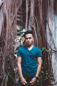 Portrait of a boy standing in forest