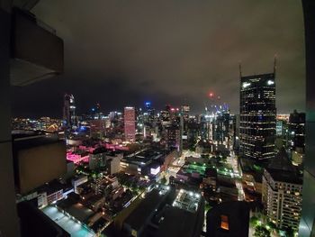High angle view of illuminated buildings in city at night
