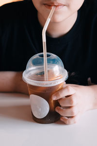 Midsection of woman drinking glass