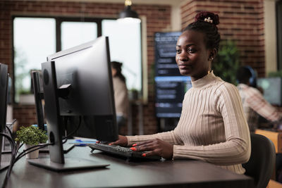 Young man using laptop at office