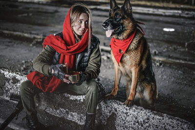 Midsection of person with dog during winter