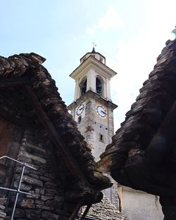 Low angle view of clock tower against sky