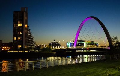 View of bridge over river at night