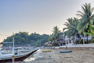 Boats moored in sea against clear sky