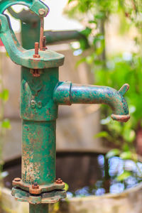 Close-up of water pipe on rusty metal