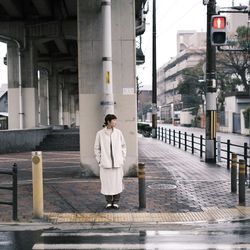 Full length rear view of man standing on street