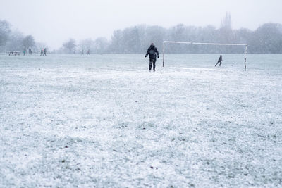 People on snowy field during winter