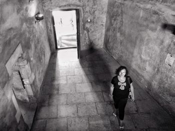 Portrait of smiling woman walking in old ruin