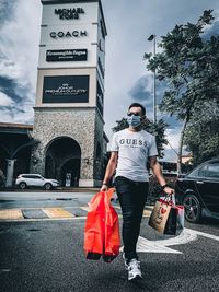 Man standing on street in city