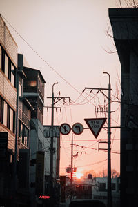 Low angle view of buildings against sky during sunset