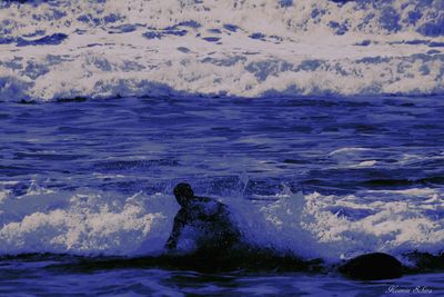 People surfing in sea