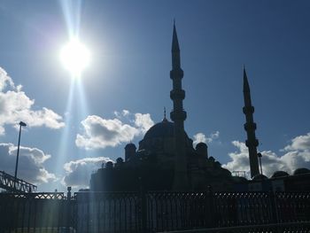 Low angle view of buildings against cloudy sky