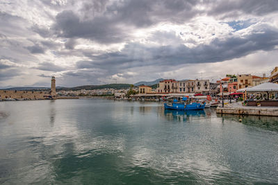 Scenic view of sea by buildings against sky