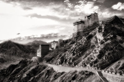 Low angle view of building and mountains against sky