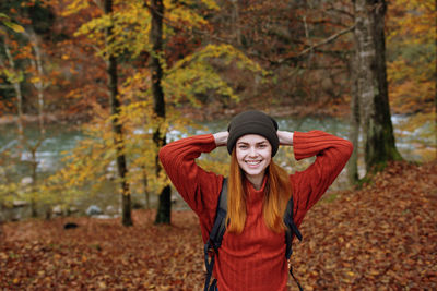 Portrait of a smiling young woman in autumn
