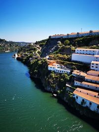 River amidst buildings against clear blue sky