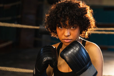 Portrait of young woman exercising in gym