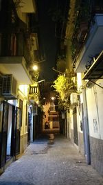 Empty walkway in city at night