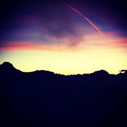 Scenic view of mountains against sky at sunset