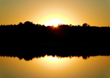 Scenic view of lake against romantic sky at sunset