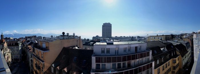 Buildings in city against blue sky