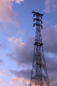 Low angle view of electricity pylon against sky