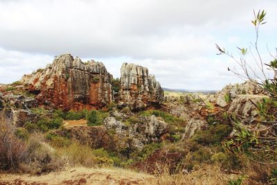 Rock formations on landscape against sky