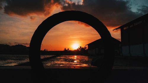 Scenic view of lake against orange sky