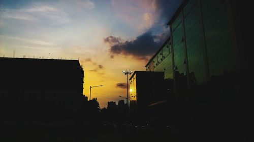 Low angle view of buildings against cloudy sky