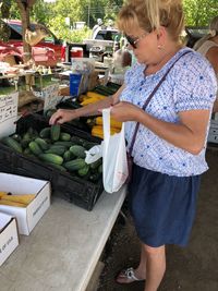 Midsection of woman holding food at market