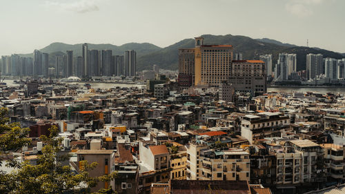 High angle view of buildings in city against sky