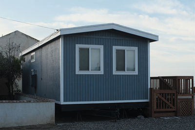 House by building against sky
