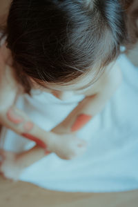 Directly above shot of girl sitting at home