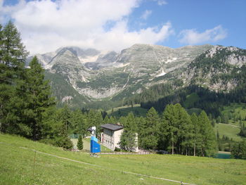 Scenic view of field and mountains against sky