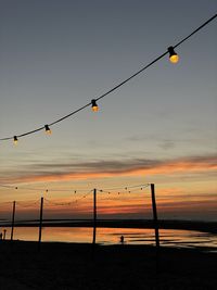 Low angle view of silhouette pole against sky during sunset