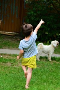 Rear view of boy standing on field