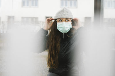 Woman wearing face mask looking away