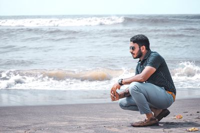 Full length of young man on beach