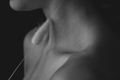 Close-up of woman against black background