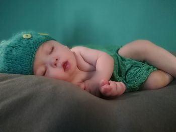 Close-up of baby sleeping on bed