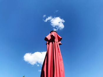 Low angle view of traditional windmill against blue sky