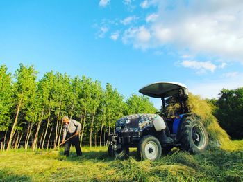 Farmer working on field by tractor