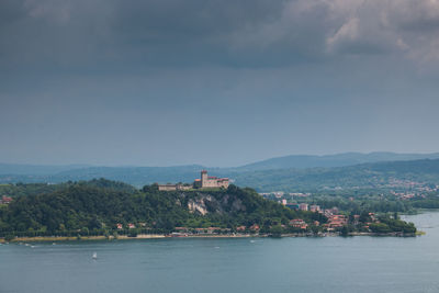 Scenic view of sea and buildings against sky