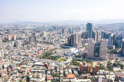 High angle view of modern buildings in city against sky