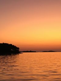 Scenic view of lake against romantic sky at sunset