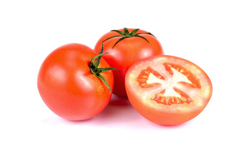 Close-up of tomatoes against white background