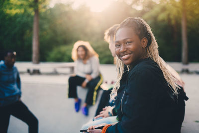 Portrait of smiling young woman standing outdoors