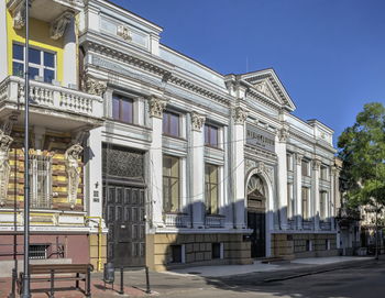 Low angle view of building against clear blue sky