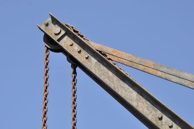 Low angle view of metallic structure against clear blue sky